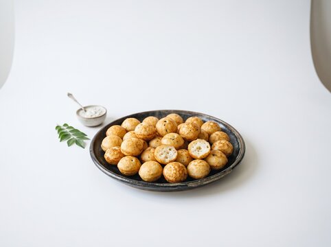 Delicious traditional Indian paniyaram dumplings served on a ceramic plate