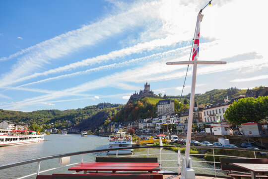 River cruise ship deck view overlooking Cochem medieval castle and historic town along the Moselle river in Germany under a sunny sky