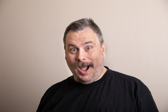 Man displays exaggerated surprised expression