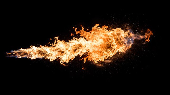 Powerful stream of orange fire on black background.