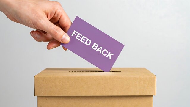Hand placing feedback card into suggestion box for customer service improvement