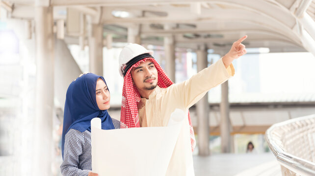 Banner Arab team hold digital tablet uae union teamwork people. Panorama arab group of people using smart tablet discuss modern muslim UAE city. Asian people smile teams meeting with copy space.