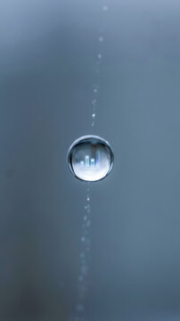 Water droplet reflection blue data driven decision making concept with suspended bubble and rising air trail in clear liquid
