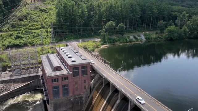 Stevenson Generating Station next to the Stevenson Dam on Lake Zoar and the Housatonic River in Monroe, Connecticut supplies clean hydroelectric power to the region - ascending aerial reveal