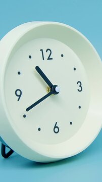 Tme lapse video of a clock time passing over a day to night on blue background.