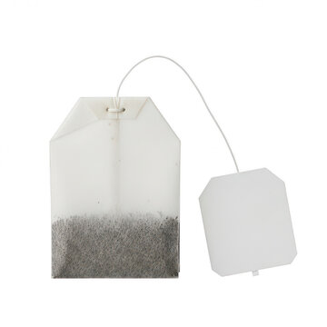 Single tea bag with white paper tag isolated on a clean white background for food design