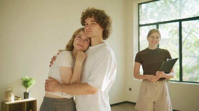 Couple shares a moment during a psychology session with a therapist in a bright room with windows