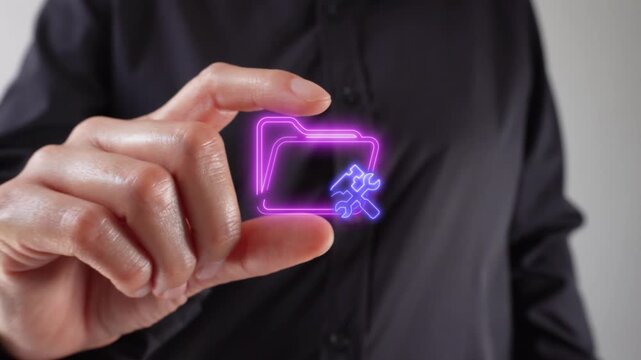 Tool and resource management. Close-up of a woman's hands holding a virtual folder icon and tools between her fingers.