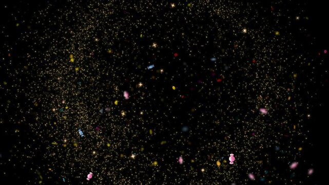 Gold glitter particles swirling with colorful candy shapes on black