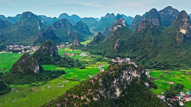 Aerial view of karst mountain landscape with green rice paddies and rural villages in Guilin, China