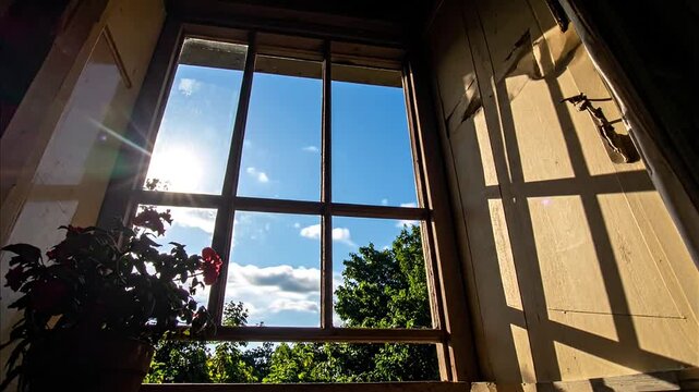 Time-lapse of Clouds Moving Past an Old Wooden Window Frame with Sunlight and Houseplant