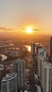 Sunset aerial drone footage above the Gold Coast city towers at Surfers Paradise, Queensland Australia - vertical video