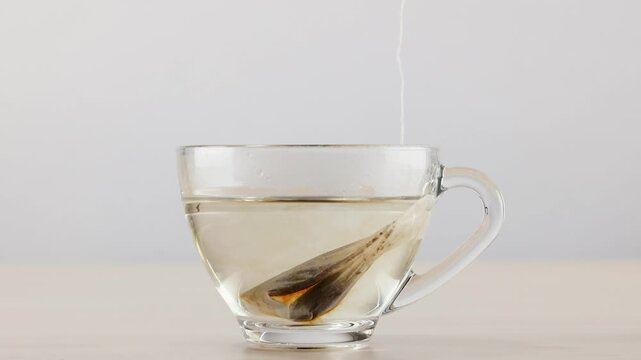 Steeping Tea Bag in Glass Cup with Hot Water