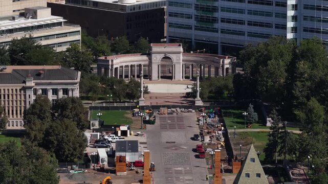 Aerial of Denver civic architecture and urban development with construction at large historic colonnade structure