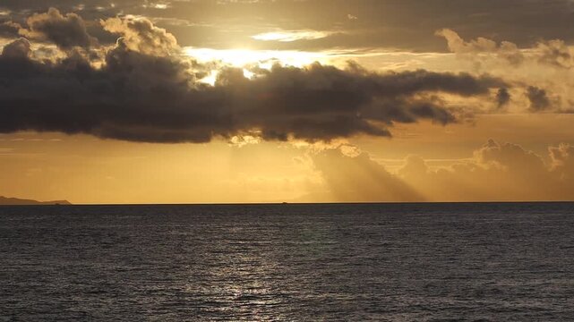Dramatic Golden Sunset with God Rays Sunbeams Over Ocean at Lembar Bay Lombok