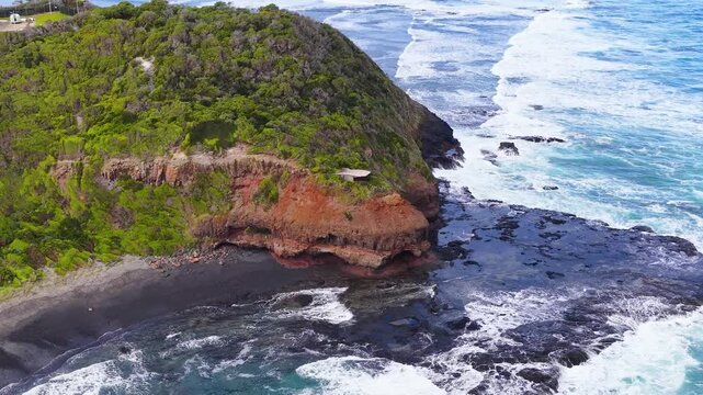 Aerial View of Red Cliffs and Ocean Waves in Mornington Peninsula