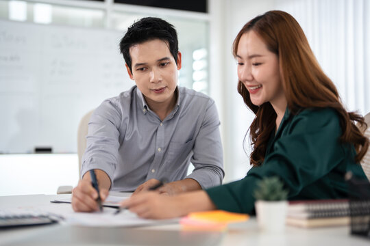 Asian Businesspeople working with papers for planning, financial analysis and chart.  discussion in boardroom for investment, risk management or budget report.