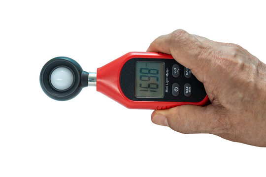 Close-up Hand of man using digital lux or light meter on transparent background