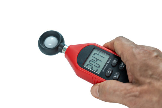 Close-up Hand of man using digital lux or light meter on transparent background
