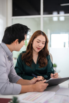 Business partners working with analysis report and advisor showing plan, Two businessman working with Financial analysts reports and planning investment at office.