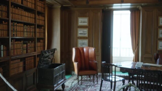 Old wood paneled study with leather chair and bookshelf, softly defocused interior; background backplate copyspace calm.