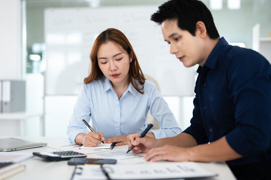 Asian Businesspeople working with papers for planning, financial analysis and chart.  discussion in boardroom for investment, risk management or budget report.