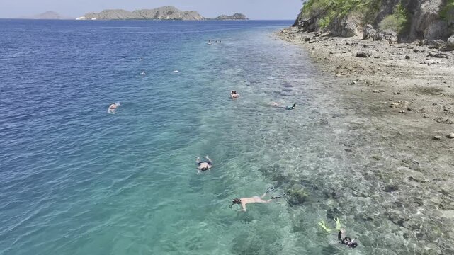 Aerial view of toursits snorkeling in the sea near Kelor island in East Nusa tenggara, Indonesia