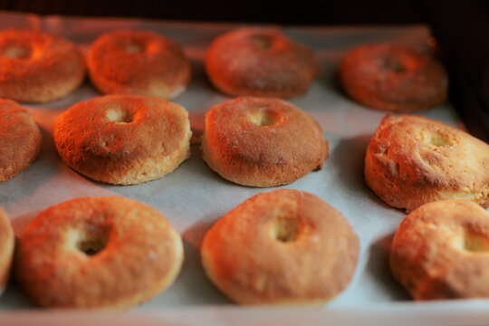 Homemade Baked Healthy Doughnuts Ready For The Oven Baking Process. Tray filled with freshly shaped nutritious pastry rings prepared for guiltless baking