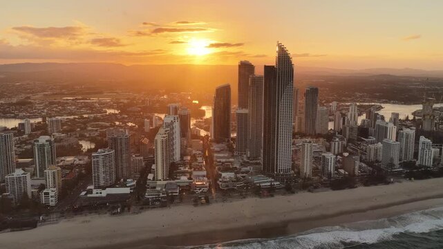 Surfers Paradise skyline at sunset, aerial drone footage over the Gold Coast towers, Queensland Australia