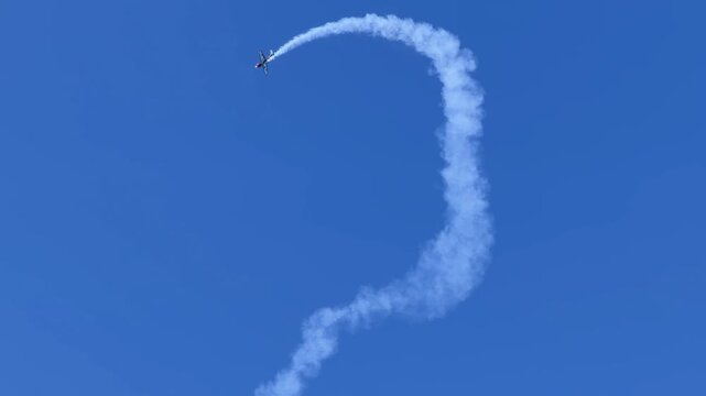 Stunt Plane Performing Aerobatics with Smoke Trails at Pacific Airshow