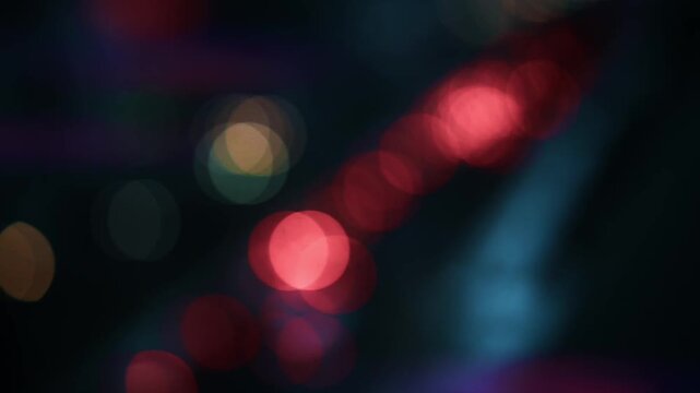 Diagonal sequence of blurry red light orbs against dark background blur bokeh lights night abstract