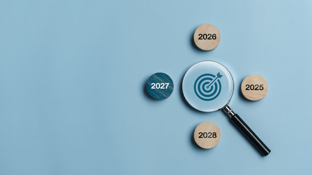 Happy New Year 2027. The concept of business strategic goals is viewed through a magnifying glass, encompassing marketing, goal setting, success, and sustainable business development.