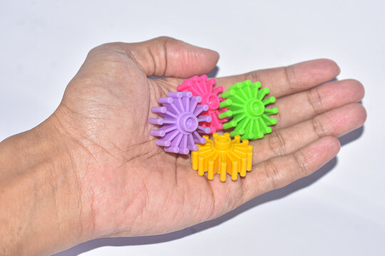 Person holding colorful plastic building block toys in hand isolated
