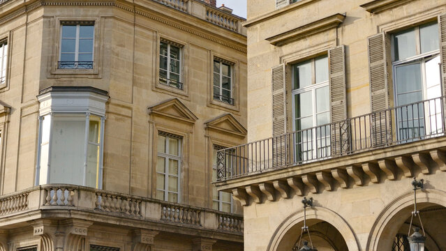 Parisian Haussmann buildings featuring classic balconies, windows, and ornate limestone facades