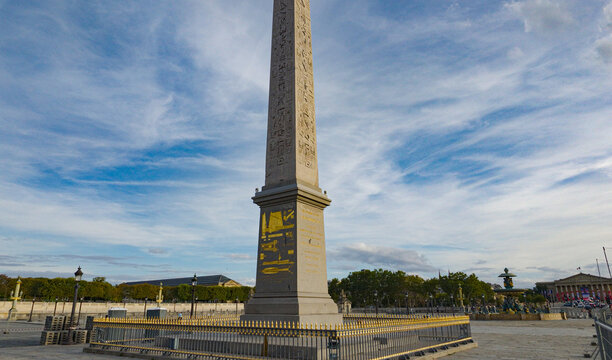 Luxor Obelisk monument with golden details under a blue sky at Place de la Concorde