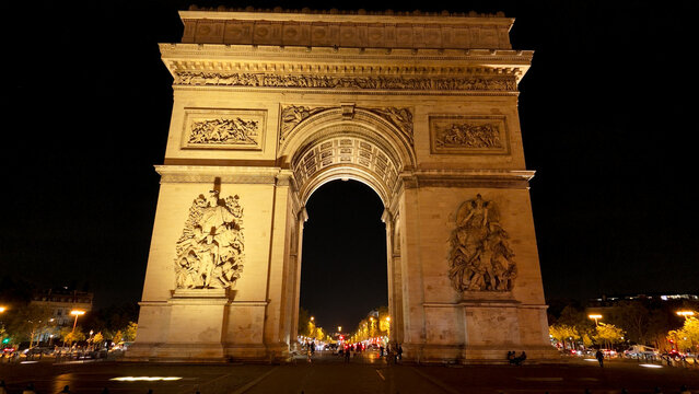 Arc de Triomphe illuminated at night, a famous historic monument and travel destination in Paris