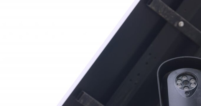 Cloudy daytime view of an AI artificial intelligence camera and solar panel on a pole.