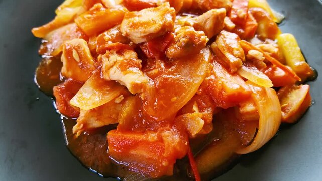 Top View Slow Motion of Sweet and Sour Chicken Dish