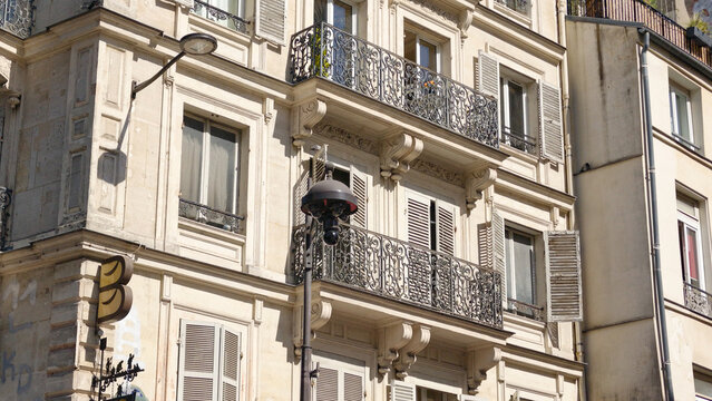 Elegant facade of a Haussmann building with balconies and windows, showcasing historic architecture in Paris