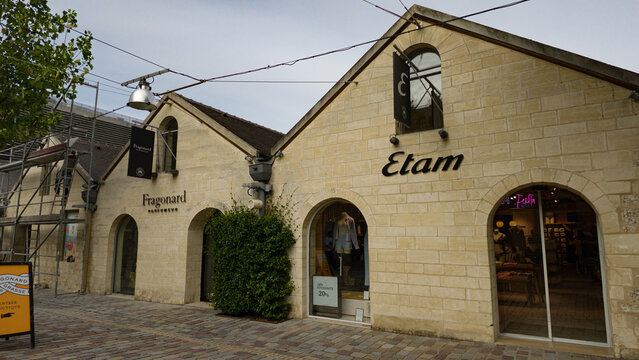PARIS, FRANCE - SEPTEMBER 1, 2026 - Bercy Village shops Fragonard and Etam, historical warehouses transformed into modern boutiques