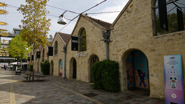 PARIS, FRANCE - SEPTEMBER 1, 2026 - Bercy Village showing a pedestrian street lined with converted stone buildings housing shops and restaurants