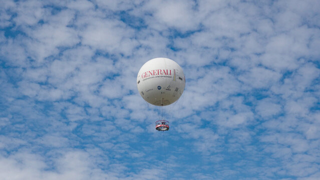 PARIS, FRANCE - SEPTEMBER 1, 2026 - Ballon de Paris Generali provides aerial sightseeing above Paris against a cloudy blue sky