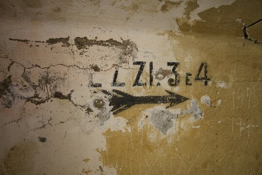 Lost Place, Ruin of a barracks, Patched wall with arrows and numbers in black on yellow, weathered plaster, Italian anti-aircraft position, Ground defence position, PL306 with 6 cannons, WW2, Vigla Mountain, Vigla, above Lakki, Lakki, Leros, Dodecanese, Girech Islands, Greece