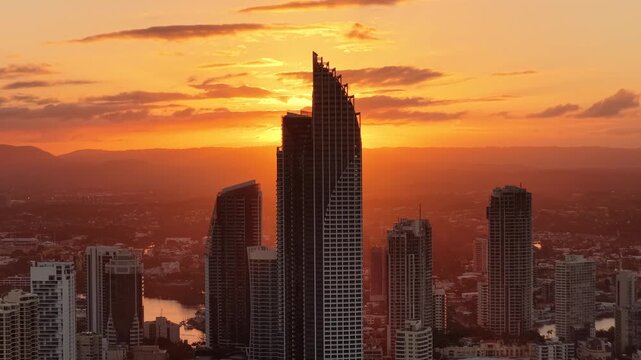 Sunset flaring between the Surfers Paradise towers, aerial drone footage, Gold Coast, Queensland Australia