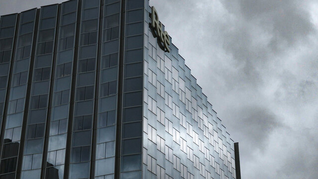 PARIS, FRANCE - SEPTEMBER 1, 2026 - Modern skyscraper with geometric facade reflecting light under an overcast sky