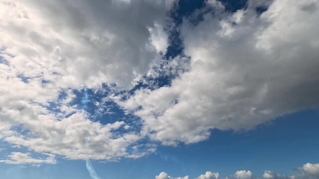 Aerobatic Jet Smoke Trails in Cloudy Sky Over Gold Coast
