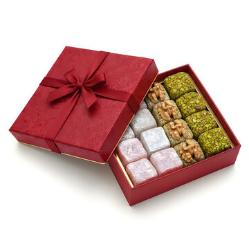 A red gift box filled with assorted traditional indian sweets and nuts for festive holidays and gifting