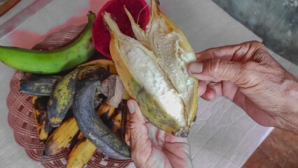 Person peeling overripe banana fruit © Marr
