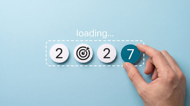 Hand placing number seven to complete twenty twenty seven loading