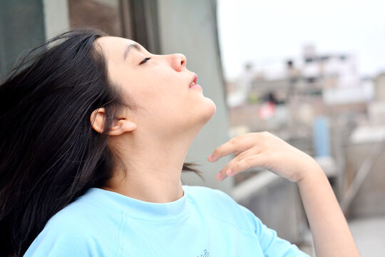 Profile of teenager girl with graceful hand movement.